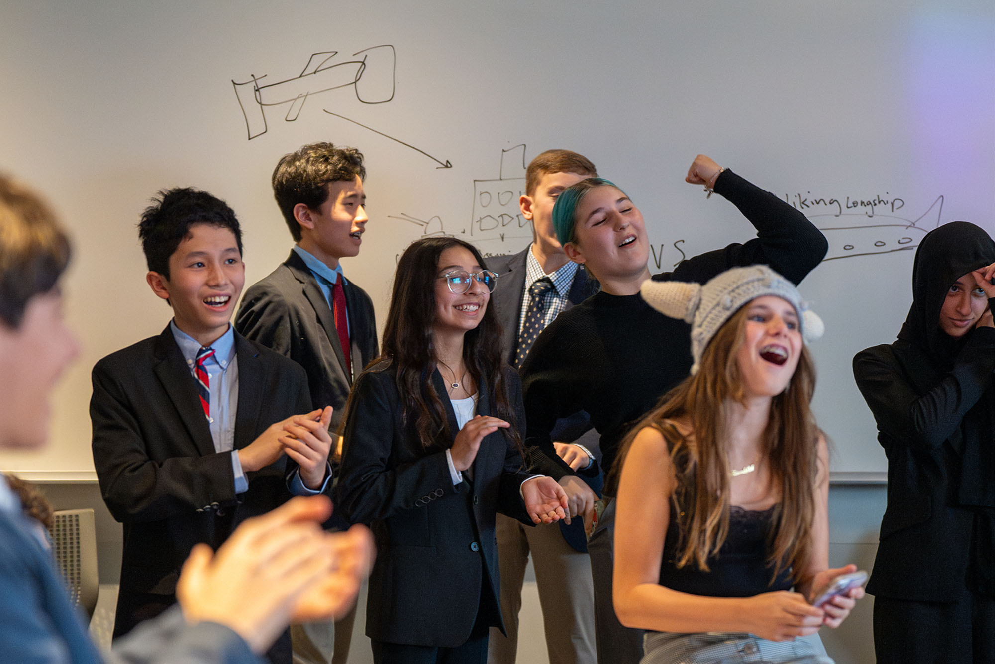 Photo: A group of middle schoolers in suits and formal attire at a recent BUA Model UN Conference