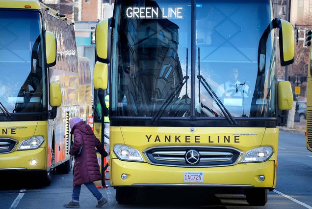 Photo: A large green shuttle bus with text reading "Green Line" on the digital display. A passenger is disembarking from the bus