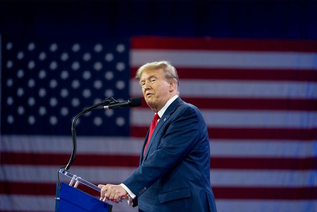 Photo: Former president Donald Trump standing at a podium with the american flag in the background