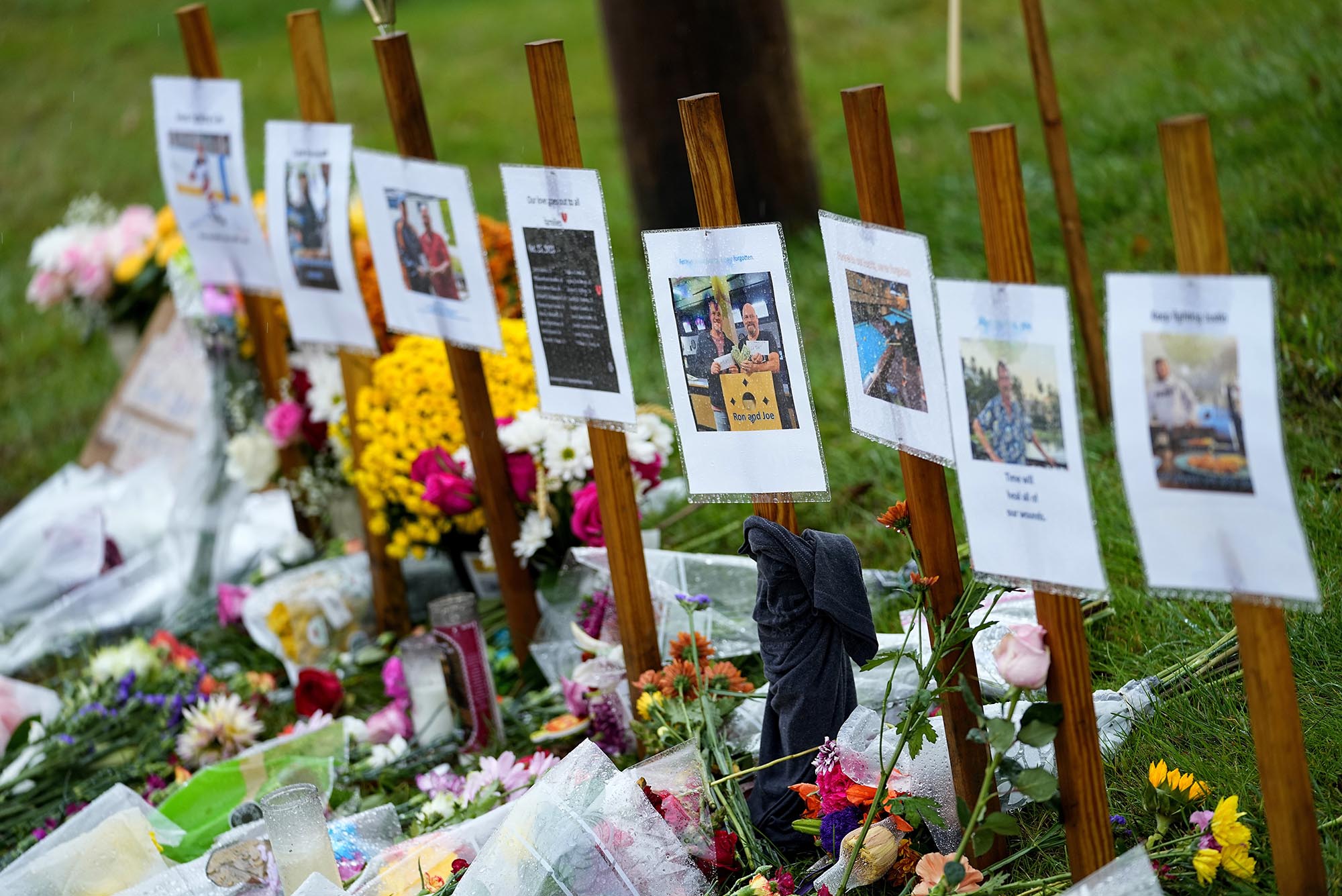 Photo: ain soaked memorials for those who died in a mass shooting sit along the roadside by Schemengees Bar.