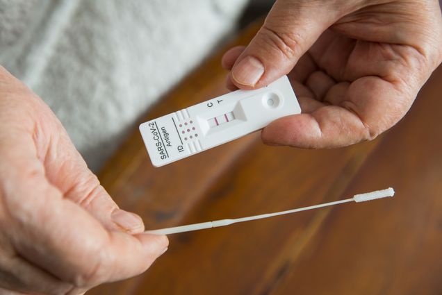 Photo: A stock image of a individual taking a COVID test.