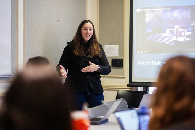 Photo: A course instructor lectures in front of a classroom full of students
