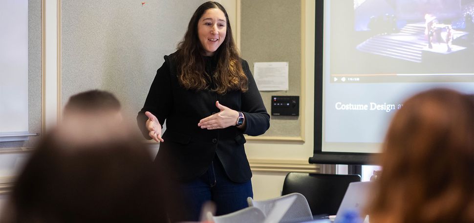 Photo: A course instructor lectures in front of a classroom full of students