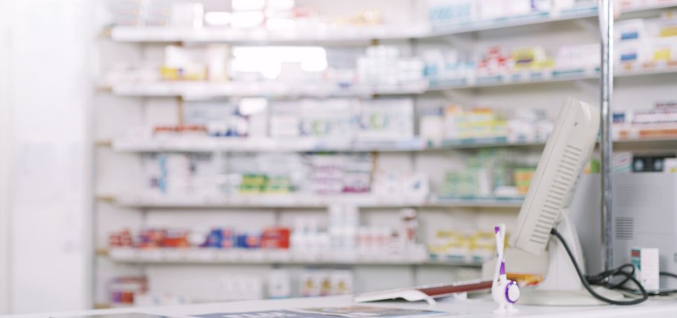 Photo: A stock shot a pharmacy, vacant of people. Shot of shelves stocked with various medicinal products in a pharmacy.