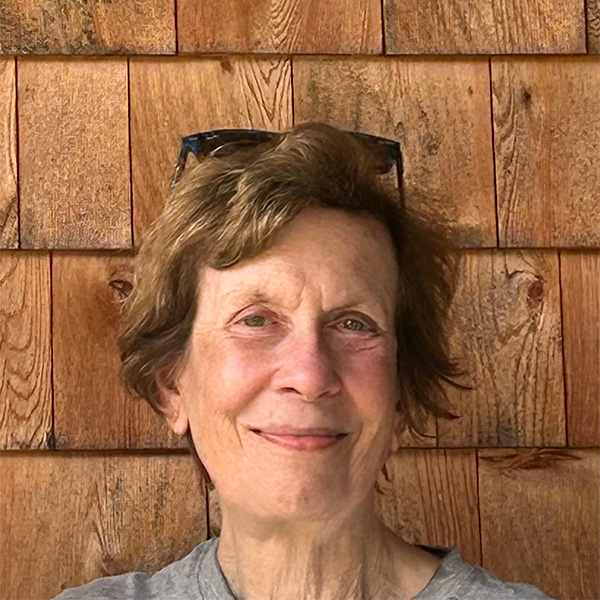 Photo: Heashot portrait of a middle aged woman wearing sunglasses on her head