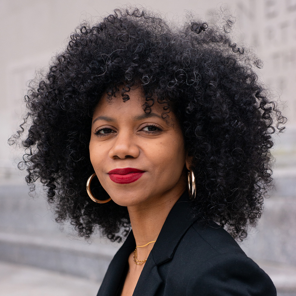 Photo: Lauren Crothers, a Black women wearing a black blazer, poses for a photo.
