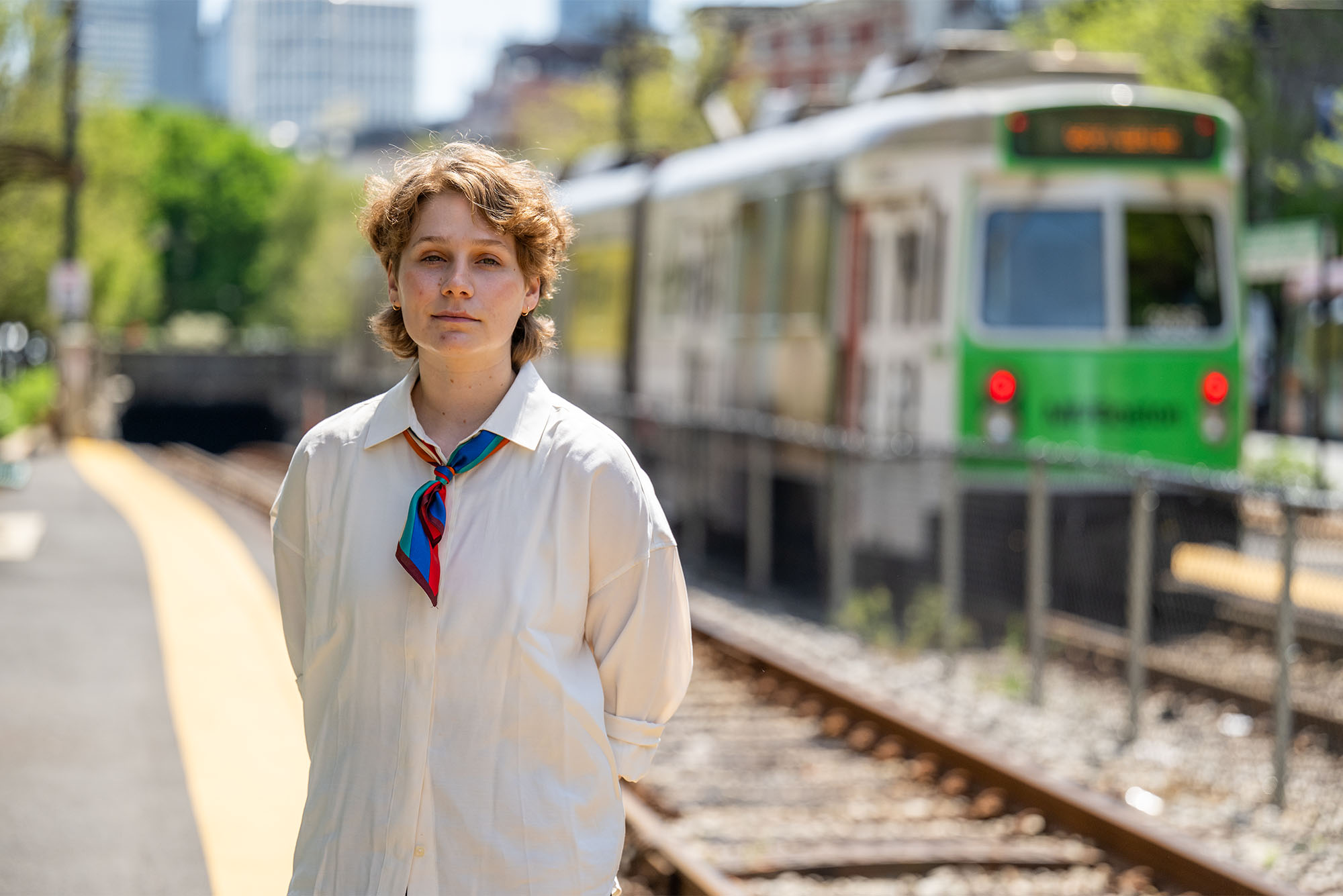 Photo: A college student standing in front of the MBTA green line train in Boston MA