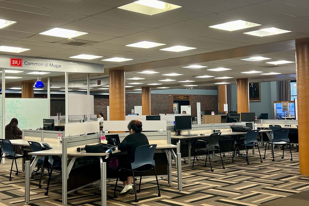 Photo: A picture of the inside of a college academic building with tables and chairs for studying