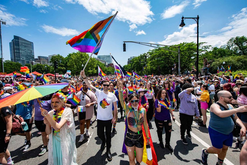 Photo: A picture of a Pride parade in Boston with many people waving rainbow flags