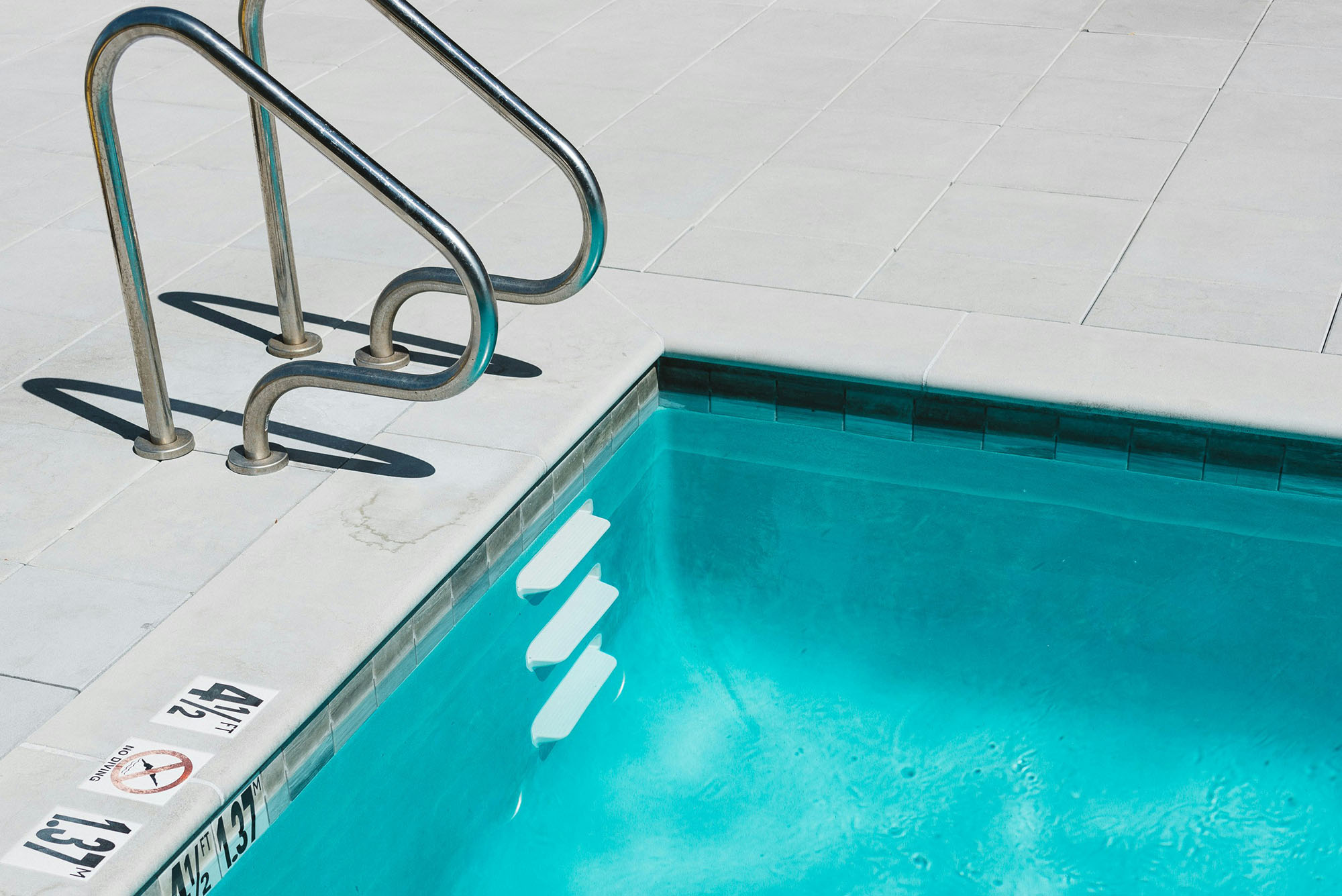 Photo: A ladder stepping down into a swimming pool