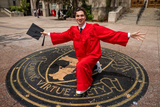 Photo: Will Loggia, a white man in his graduation cap and gown, for his vlog.