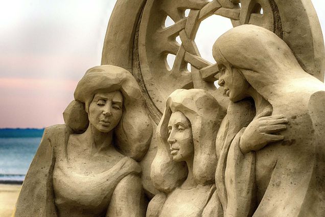 Photo: A picture of a sand castle sculpture featuring three women
