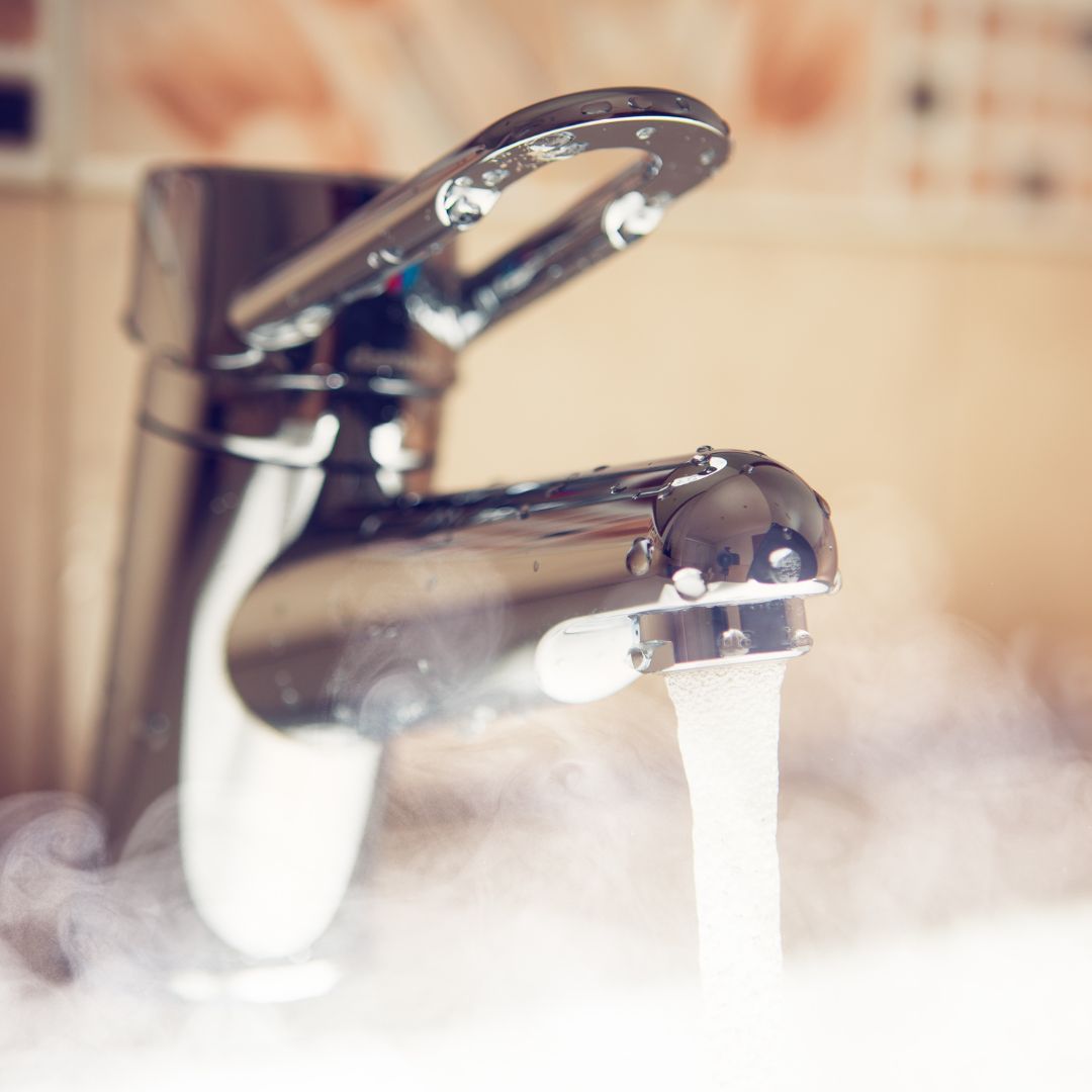 Photo: Water tap with hot water stream, closeup view