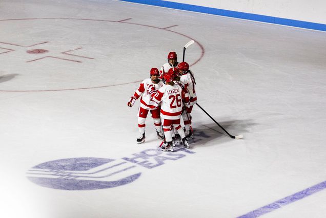 Photo: BU Women's Hockey players celebrating on the ice