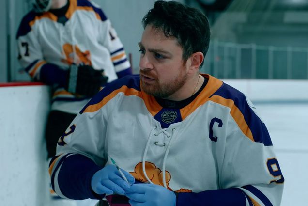 Photo: A hockey player in a white, blue and yellow jersey