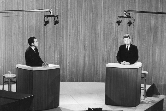 Photo: A black and white photo of a televised debate between Richard Nixon and John F. Kennedy.