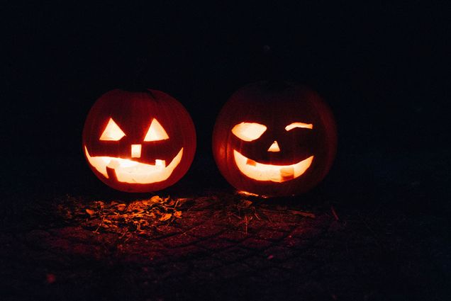 Photo: Two Jack-o-laterns lit from within.
