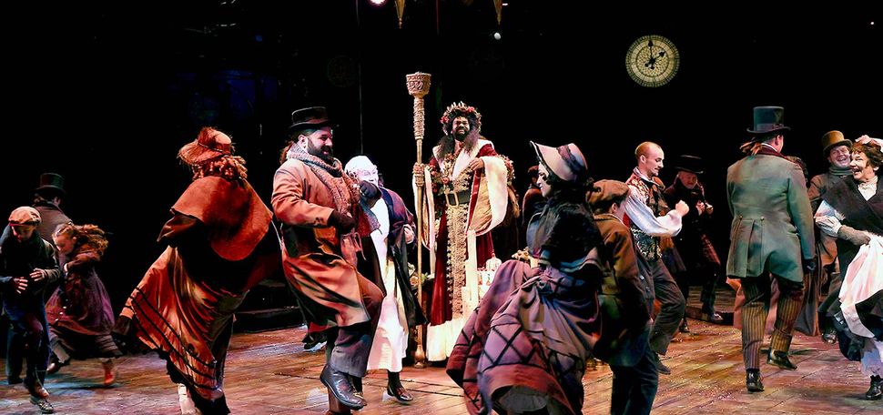 Photo: A group of people performing on stage for A Christmas Carol.
