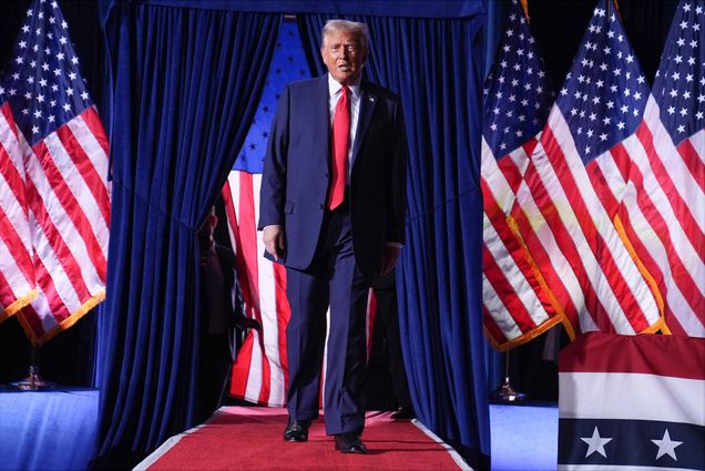 Photo: Donald Trump walking down a stage lined with American flags