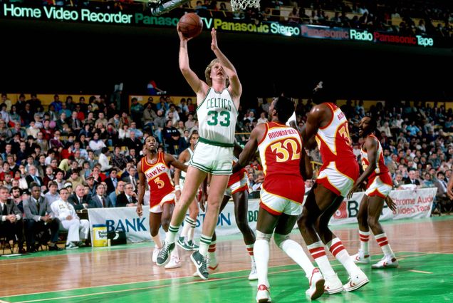 Photo: Larry Bird of the Boston Celtics jumping up to dunk a basketball during a 1984 game