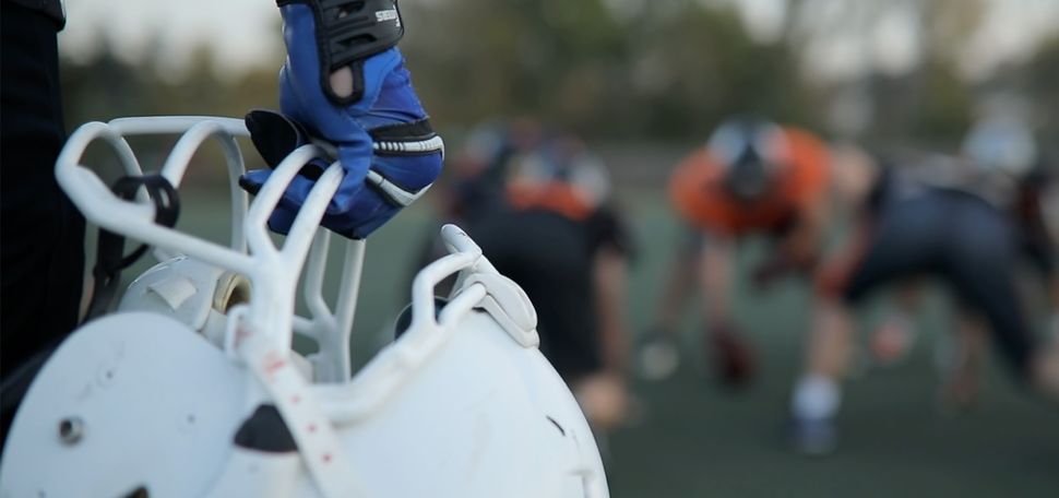 Photo: A stock image of a football player holding their football helmet.