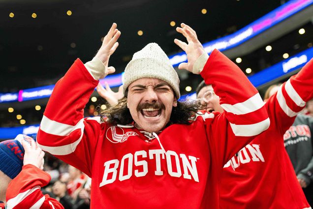 Photo: A male student at a Boston University hockey game exclaiming in the stands