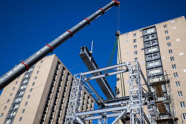 As part of the ongoing Warren Towers renovation, a crane preps the building with steel beams for its renovation process.
