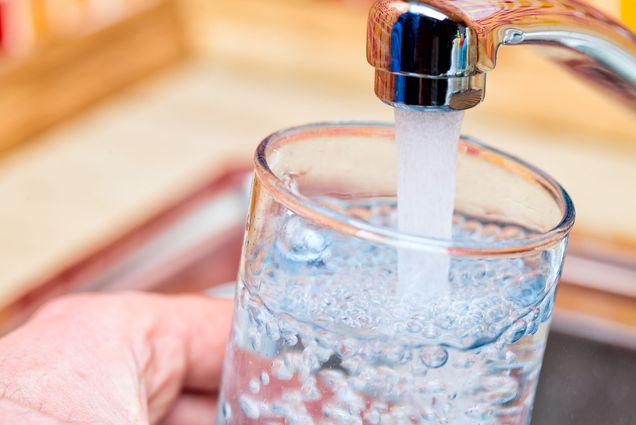 Photo: A person filling up a glass of water at a sink