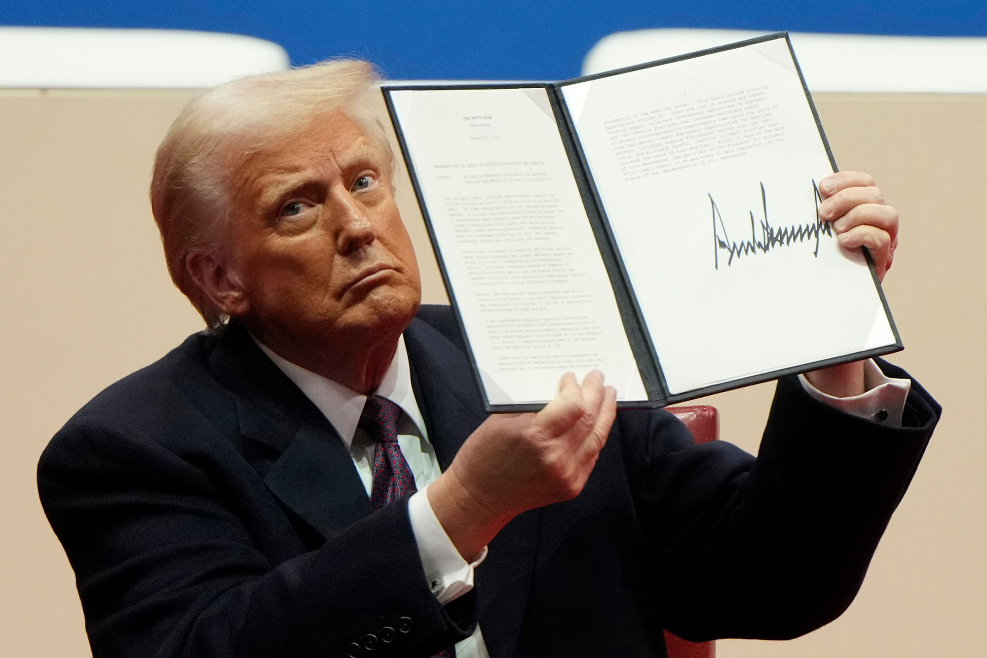 Photo: Donald Trump holding up a signed executive order