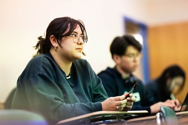 Photo: Three students sitting in a classroom