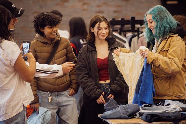 Photo: Students browse the available clothing options at the clothing swap at the BSU Ballroom Feb 1. The event was part of BU’s Weeks of Welcome (WOW), campus wide events planned by the Campus Activities Board and Student Government to welcome new and returning students to campus. Students could exchange clothes while also donating some to a combined BU closet. Photo by Halle Amankwah-Akuffo (Pardee '25)