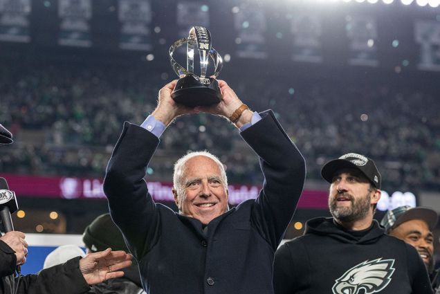 Philadelphia Eagles owner Jeffrey Lurie hoists the George Halas Trophy after the NFC Championship NFL football game against the Washington Commanders, Sunday, Jan. 26, 2025, in Philadelphia. The Eagles defeated the Commanders 55-23. Photo by Lauren Bacho via AP