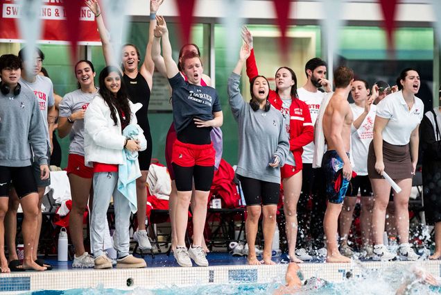 Members of BU’s men’s and women’s swimming and diving teams cheer on teammates on the opening day of the Terrier Invite, November 22, 2024. The Terriers will compete in the 2025 Patriot League Championship February 19-22 at Bucknell University. Photo by Matt Woolverton