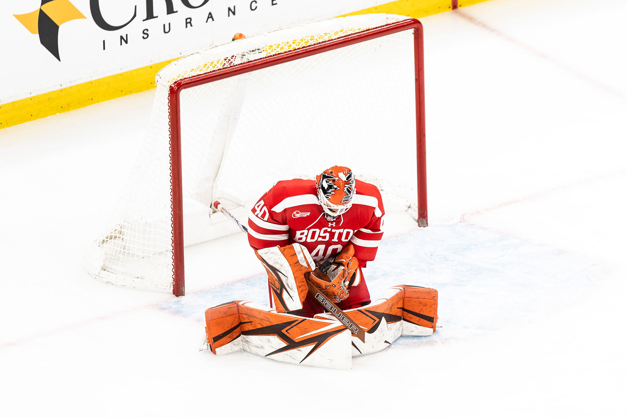 Photo: Yegorov saving a shot during the February 3 Beanpot semifinal game against Harvard at TD Garden. His orange pads are from his Omaha Lancers uniform, but he’ll use his recently acquired scarlet and white pads for upcoming games. Photo by Fia McCarty/BU Athletics