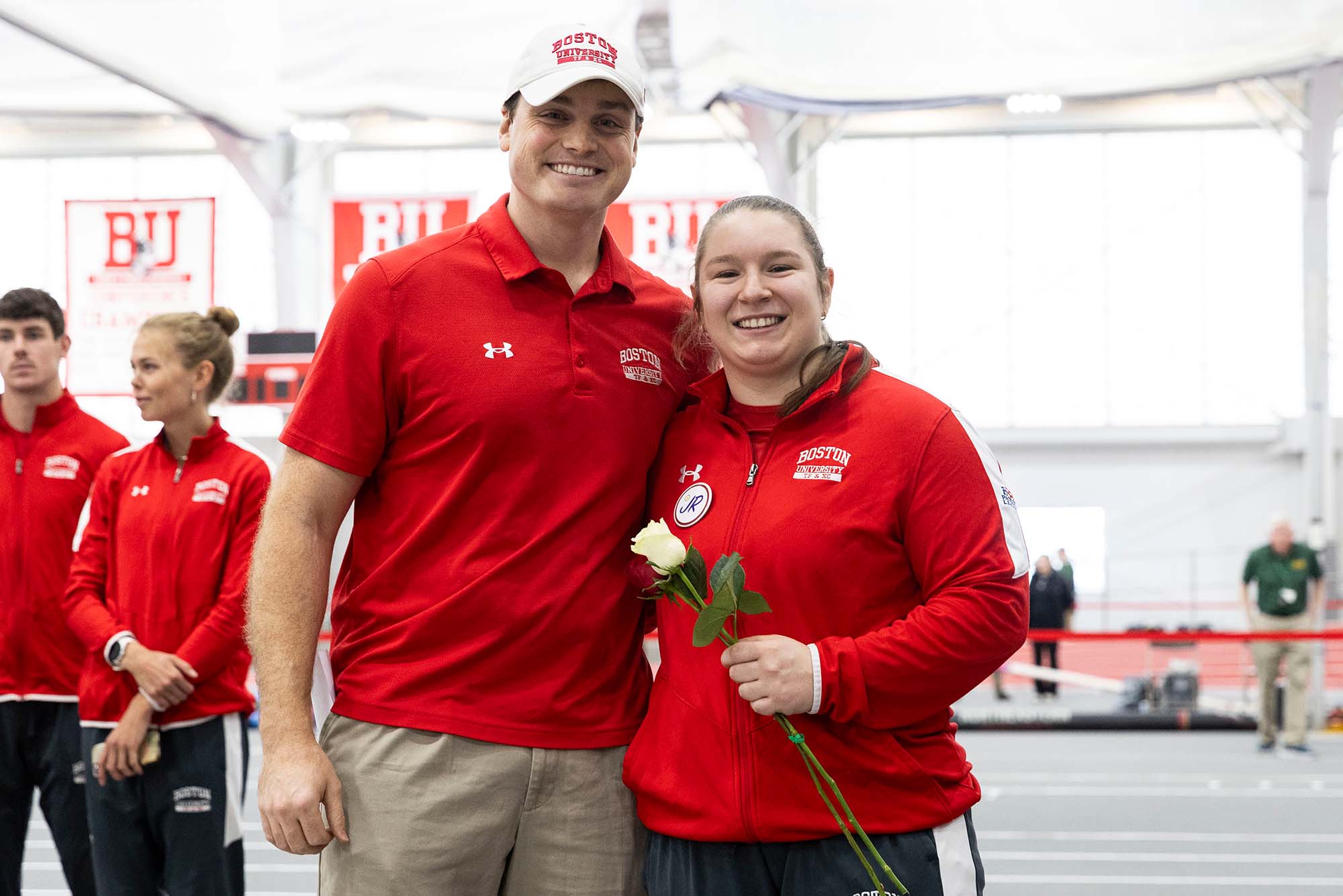 Photo: Two Boston University associated coaches/athletes pose for a photo at the indoor track and field center on BU's campus