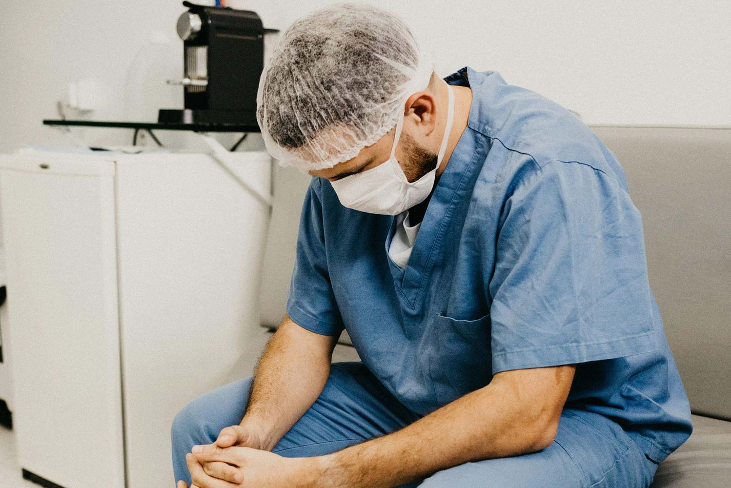 Photo: A doctor sitting with an air of sadness over them