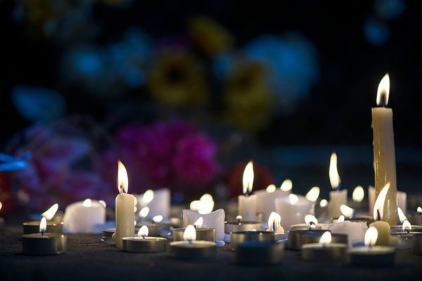 Photo: A photo of candles melting for a makeshift vigil.