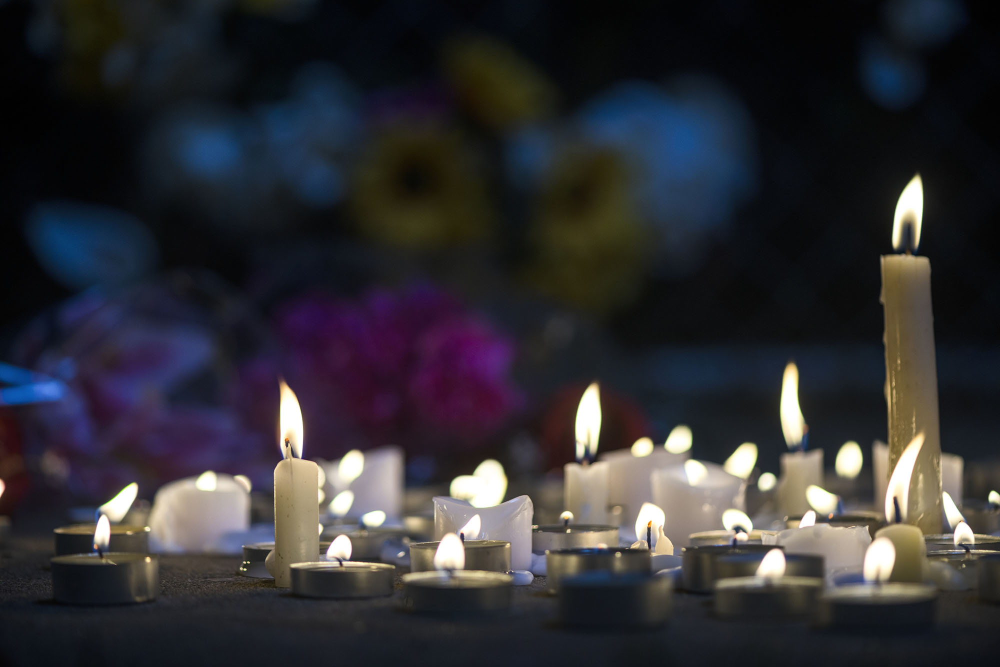 Photo: A photo of candles melting for a makeshift vigil.