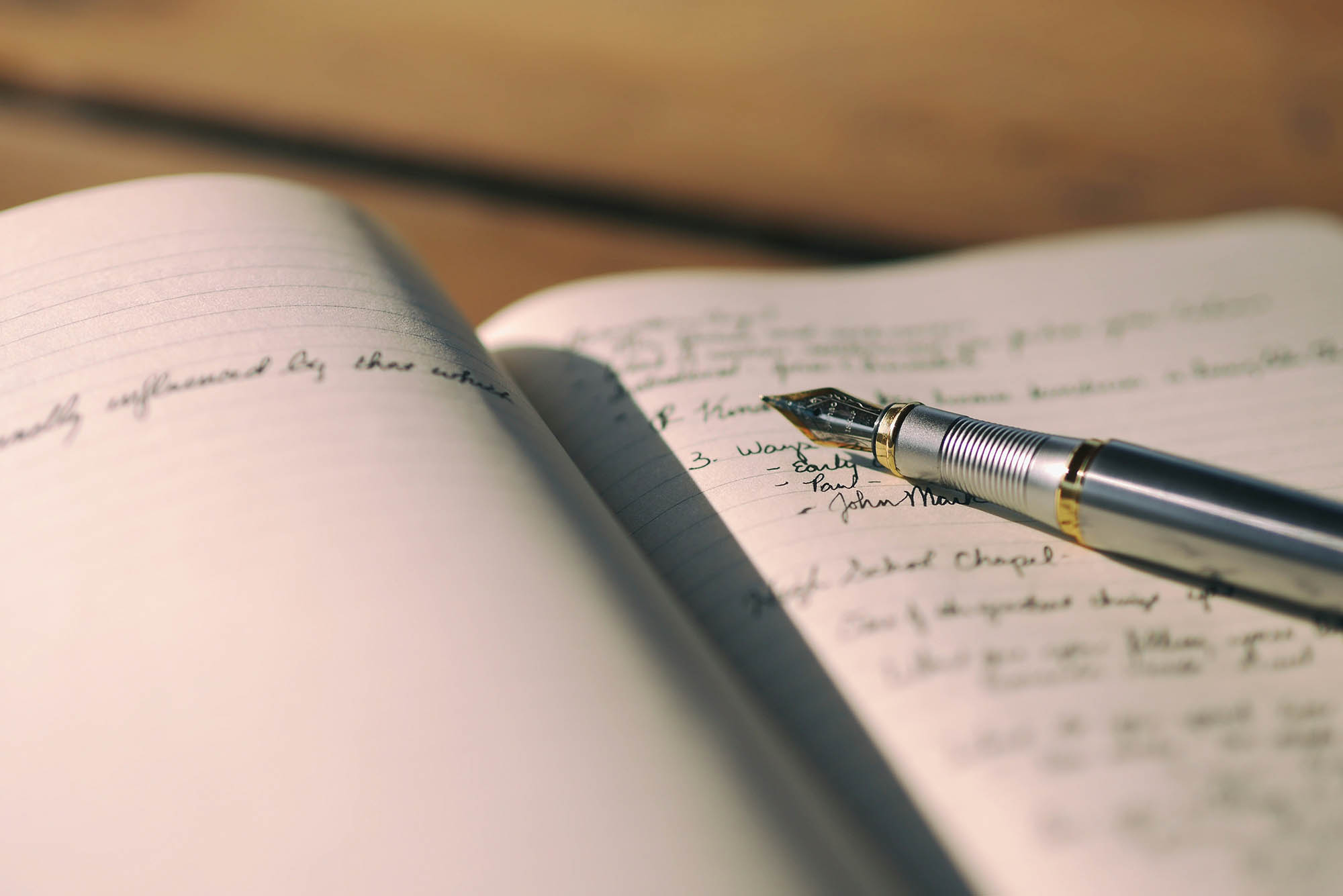 Photo: A stock image of a fountain pen on a journal.