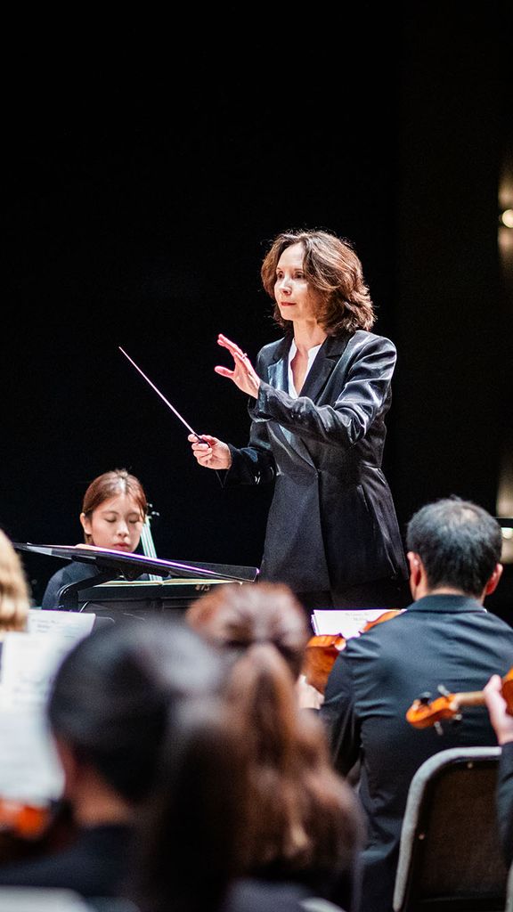 Photo: Sarah Ioannides, BU's new director of orchestral activities, conducting an orchestra on stage