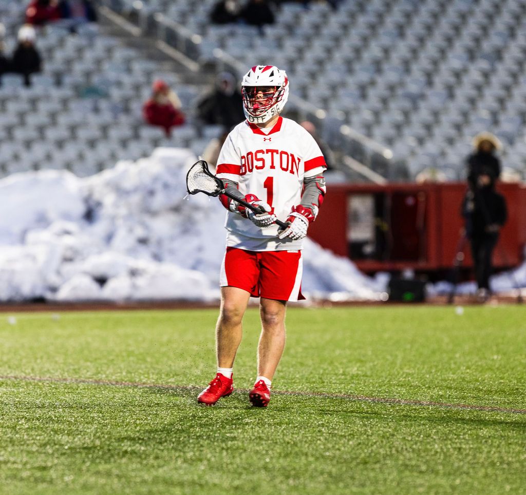 Boston University Men's Lacrosse Player, Jimmy O'Connell in uniform, playing on a field.