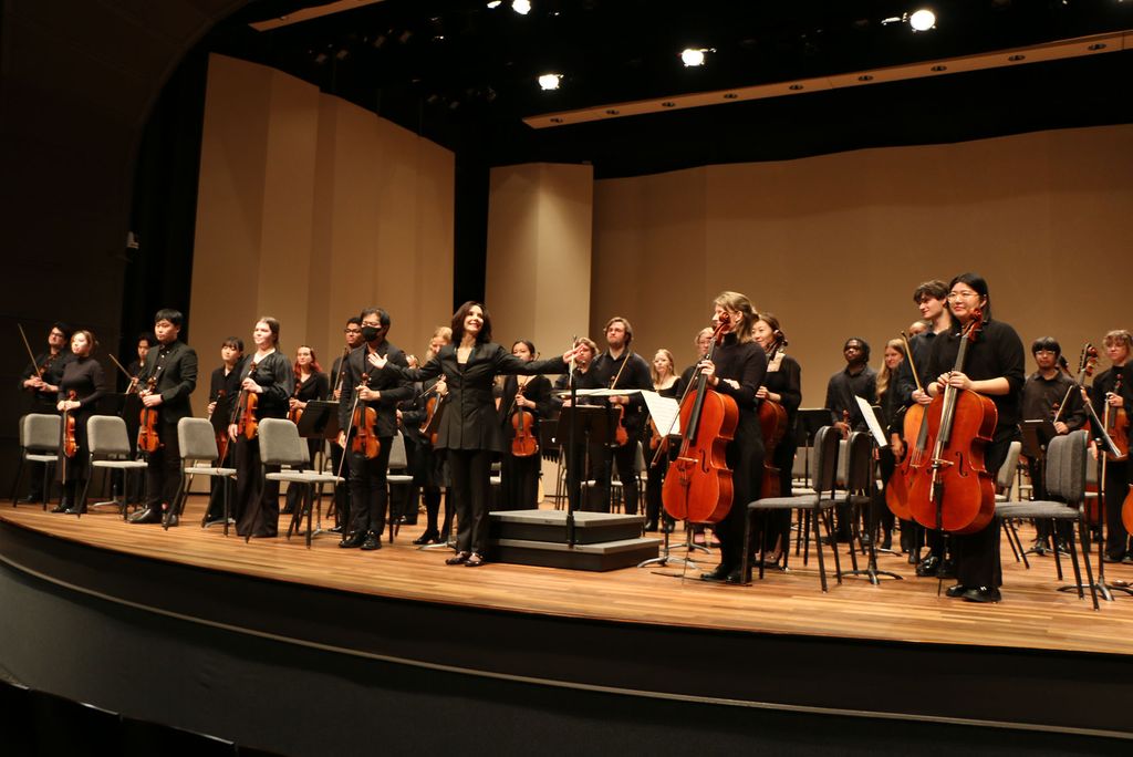 Photo: Sarah Ioannides, BU's new director of orchestral activities, conducting an orchestra on stage