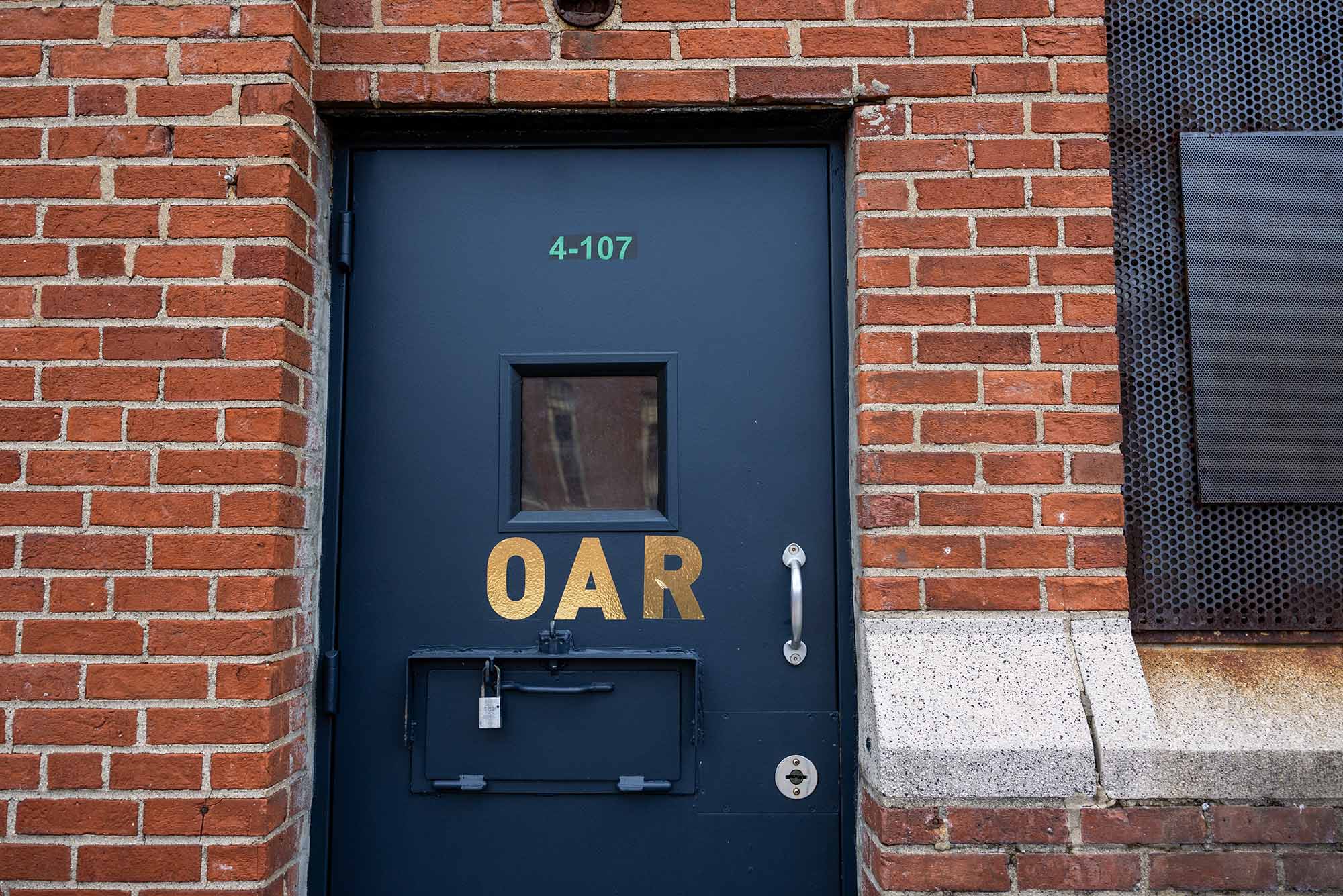 Photo: A large blue door with letters "OAR" on the front in gold paint
