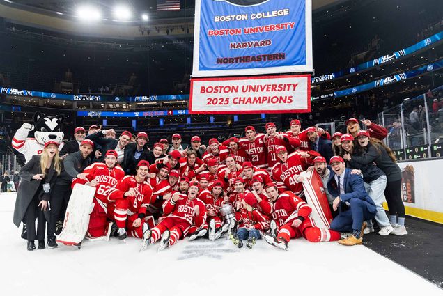 Photo: The BU Terriers Mens Ice Hockey Team, Winners of the BU Beanpot Trophy. The team is seen here posing with the trophy.