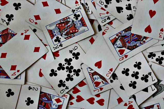 Photo: A deck of cards scattered across a table
