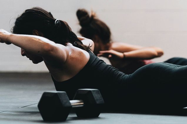 Photo: Stock image of two women doing pilates on yoga mat.
