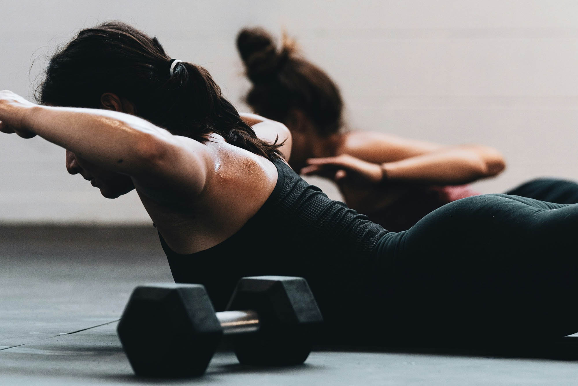 Photo: Stock image of two women doing pilates on yoga mat.