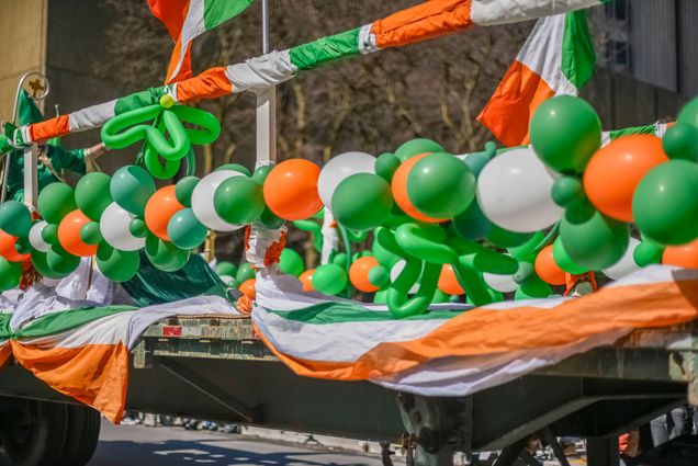 Photo: A Saint Patrick's Day Parade float with green, white, and orange balloons