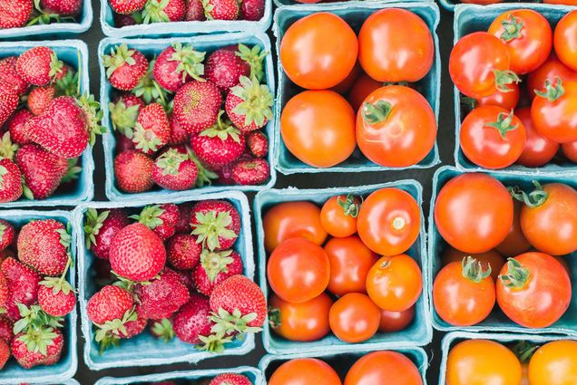 Photo: An overhead view of baskets of strawberries and tomatoes