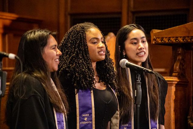 Photo: Three women singing as part of a choir